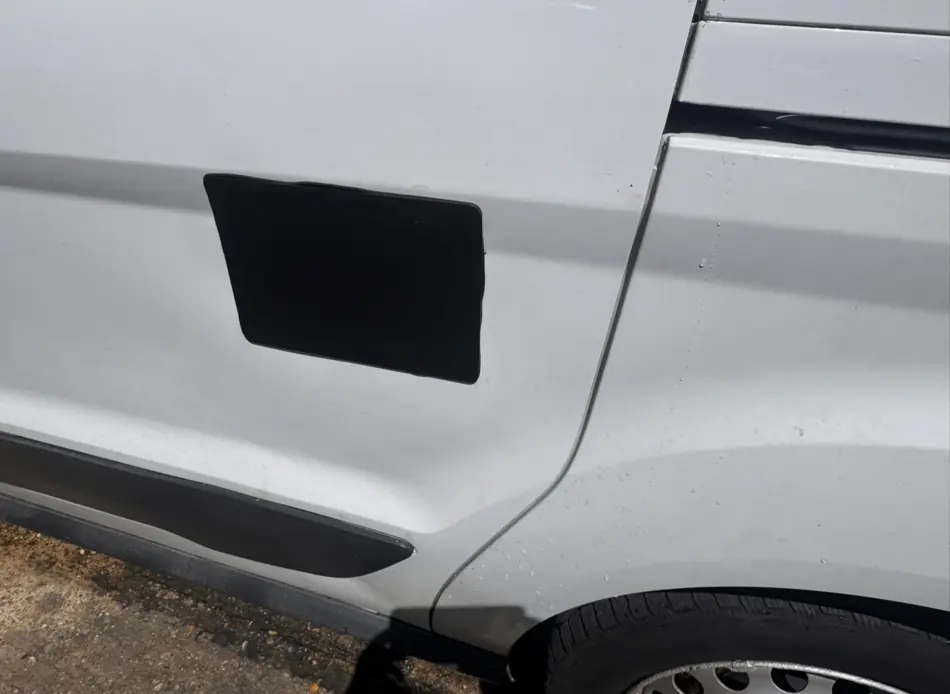 Black external security plate on a white van side door