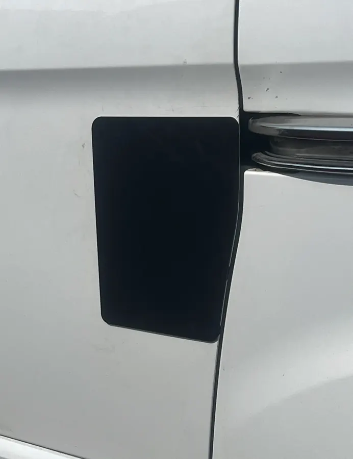 Close-up after repair, with a fitted black protective cover plate