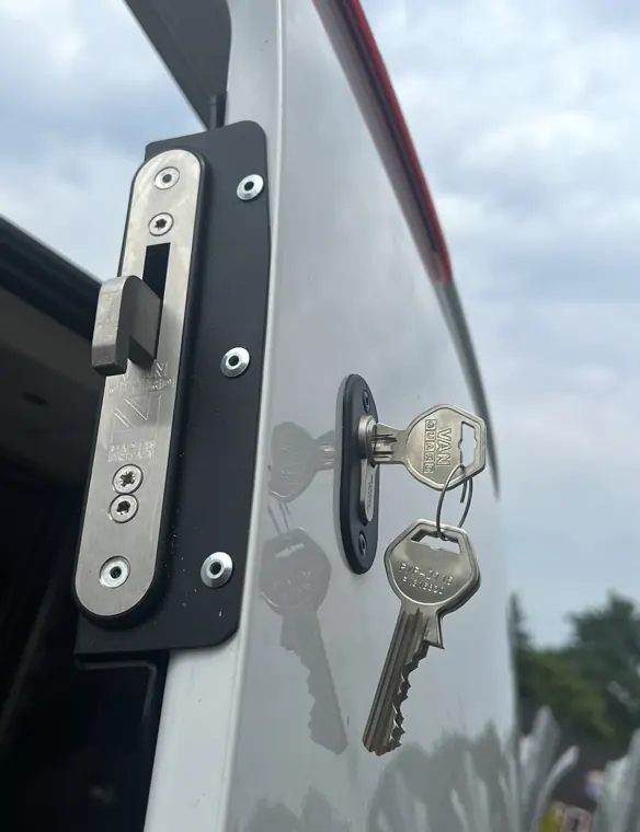 Hooklock assembly on silver van door with key inserted