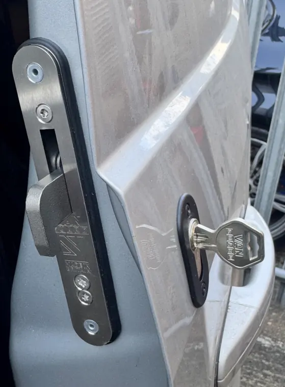 Hook-shaped bolt and cylinder on silver van door