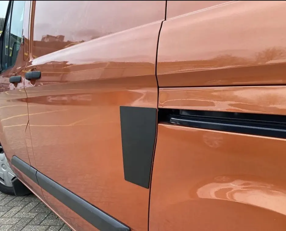 Black external repair plate fitted to an orange van sliding door