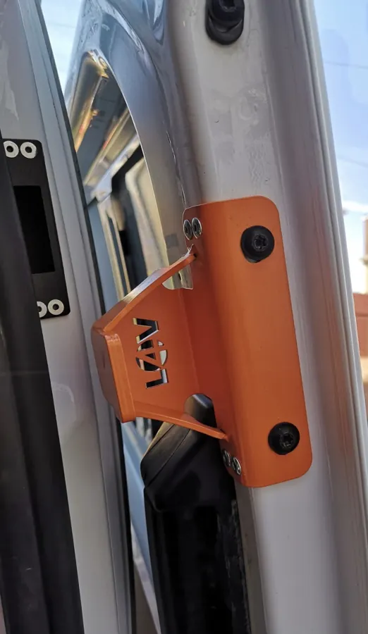 Orange anti-peel keeper installed on van door pillar