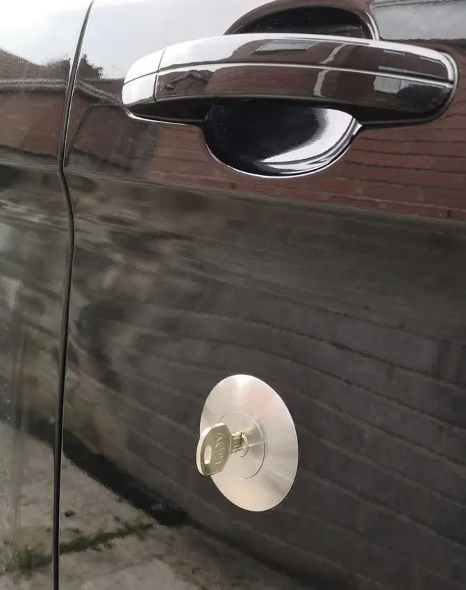 Black van door with circular stainless-steel replacement security lock