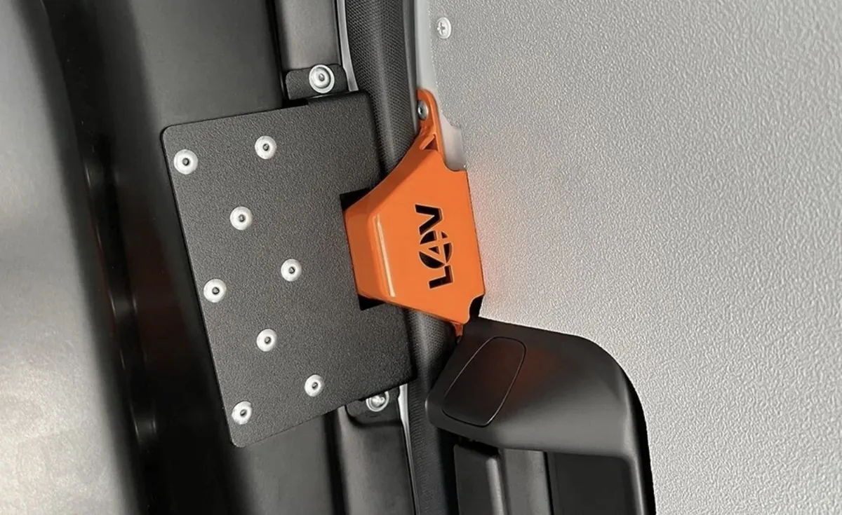 Orange anti-peel bracket engaged on a van sliding door