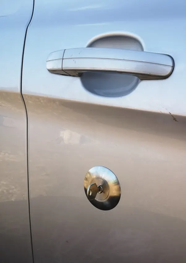 Silver van door with security lock installed below exterior handle